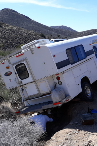 Truck camper stuck on desert road