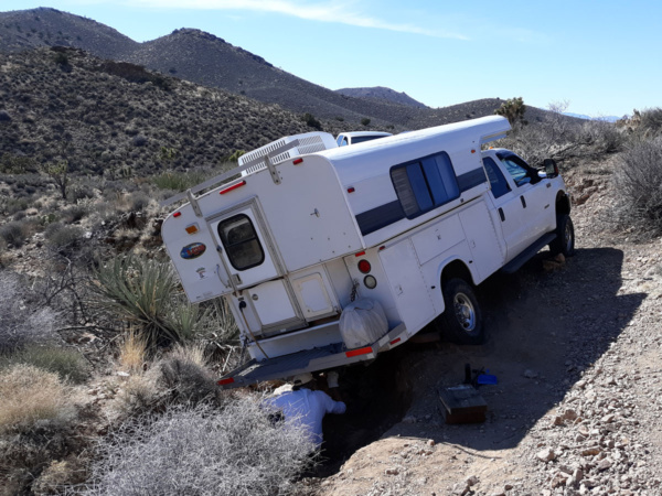 Truck camper stuck on desert road