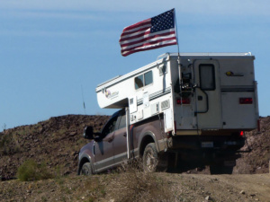 US flag flies over truck camper